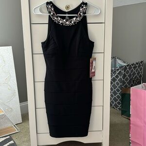 Size small black fitted semiformal dress with beautiful beaded neckline.